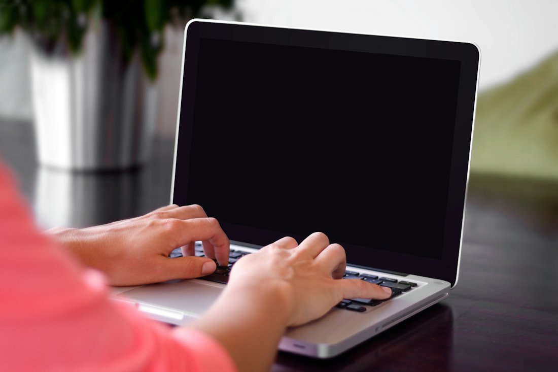 A person using a laptop to browse the site