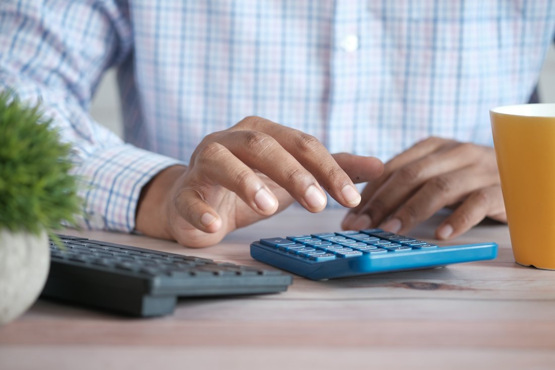 Working out the numbers on a calculator at a desk