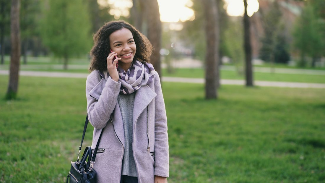 A woman speaking with a claim specialist on the phone