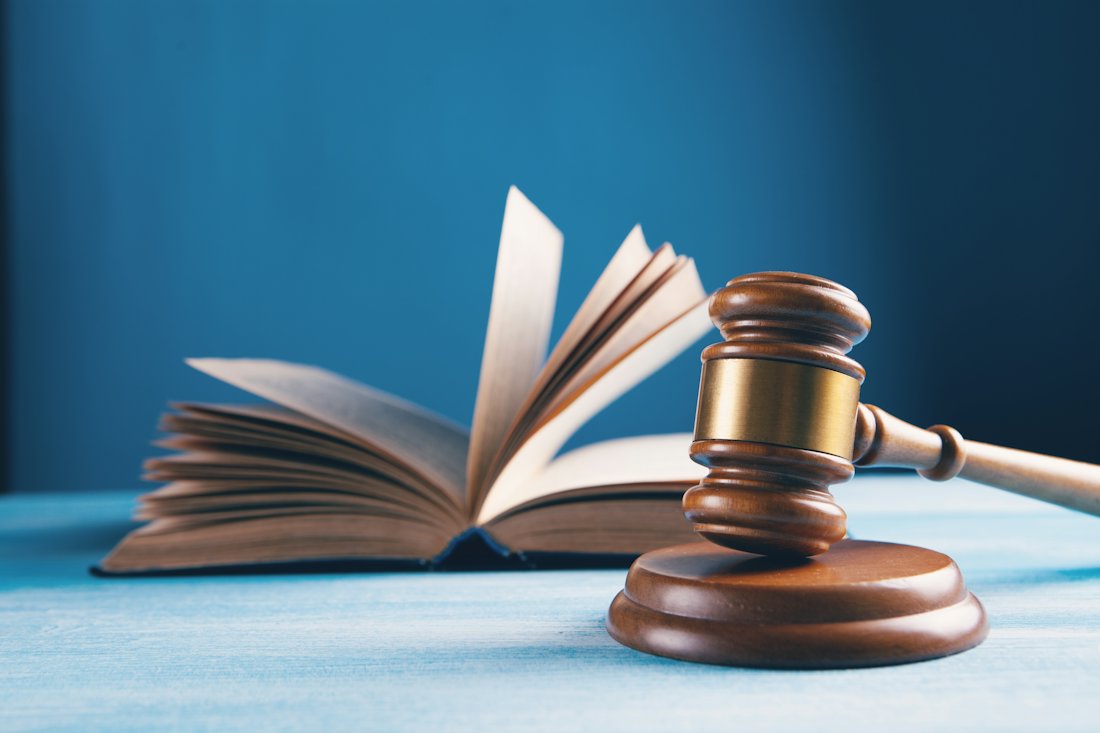 A judge's gavel resting beside an open law book