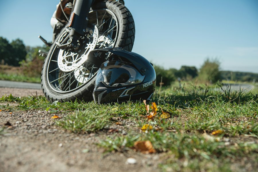 A motorcycle lying on its side at the roadside after a collision