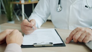 A doctor completing medical records